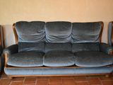 a blue couch and two chairs in a living room