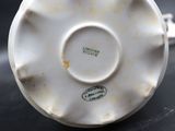 a white porcelain cup and saucer on a table