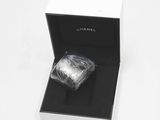 a box with a ring inside of it on a white surface