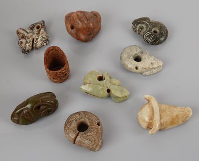 several different types of carved objects are displayed on a white surface