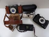many different types of cameras sitting on a table