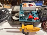 une boîte à outils posée sur une table à côté de deux tronçonneuses