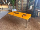 a yellow table with a knife and fork on it