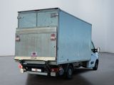 a blue truck that is parked in a room