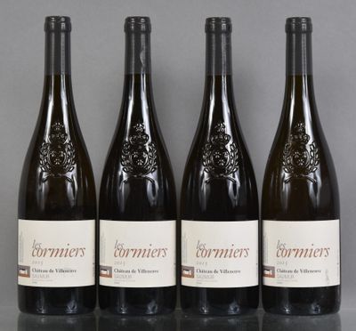 four bottles of wine are lined up on a table