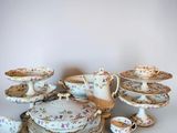 many plates and cups and saucers on the table
