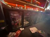 a blurry photo of a bar with a bunch of bottles on the counter