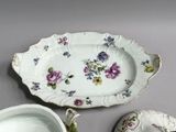 three plates and a bowl sitting on a table