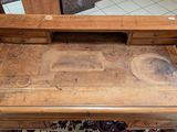 a wooden desk with a drawer on top of it