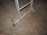 a metal gate that is sitting in the dirt