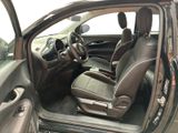 the interior of a car with the door open and the driver ' s seat up