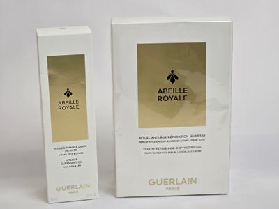 two boxes of perfume sitting on top of a white table