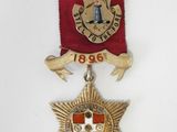 an image of a red and gold medal with a star on it
