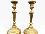 pair of antique brass candlesticks on wooden bases