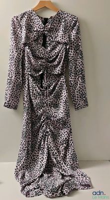 leopard print dress on hanger against white wall