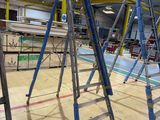 many ladders that are sitting in the middle of a room