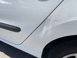 a close up of a car with a denting on the side