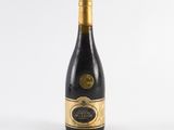 a bottle of wine sitting on top of a white table