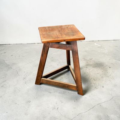 an image of a small wooden stool in a room