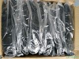 a cardboard box filled with a bunch of black skateboards