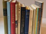 a lot of books that are stacked together on a table