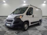 the white van is parked on a checkered tile floor