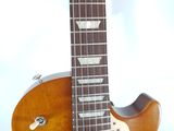 a close up of a guitar that is on a table