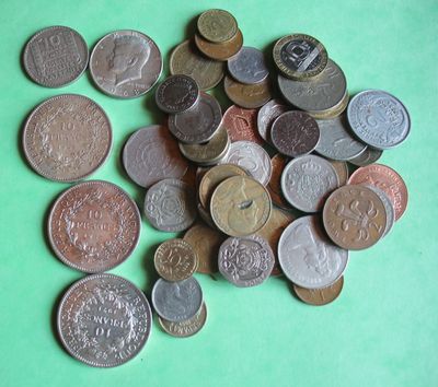 a pile of coins sitting on a green surface