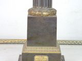 a statue of a man standing on top of a pedestal