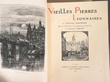 an open book with a picture of a city on it