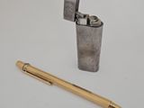 une image représentant un briquet et un stylo posés sur une surface blanche