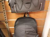two bags hanging on the wall next to each other