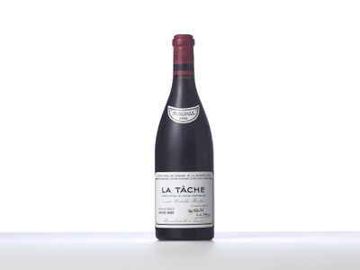 bottle of red wine sitting on top of a white table