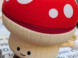 a small stuffed mushroom sitting on top of a box