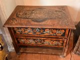 a small wooden table with a drawer on top of it