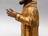 an old wooden statue of a man with a beard and a robe