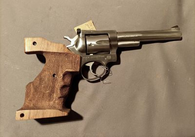 a revolver with a wooden handle on a table