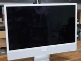 a computer monitor sitting on top of a wooden table