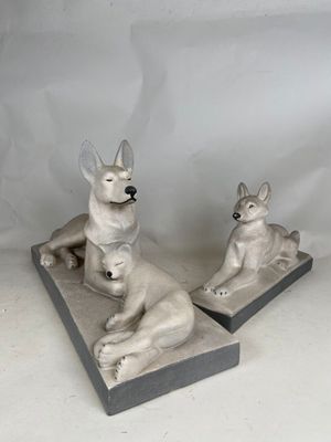 two statues of a dog and a cat sitting on top of each other