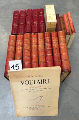many books stacked on top of each other in a box
