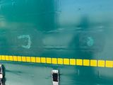 a green train with yellow stripes on the side of it