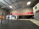 the inside of a gym with a bench and a banner hanging from the ceiling