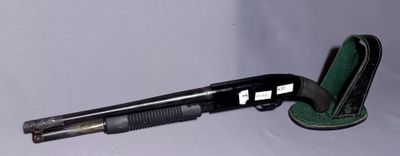 a gun that is laying on the ground next to a case