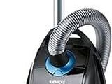 black and blue vacuum cleaner with hose on top of it