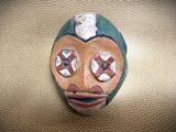 a ceramic mask on the wall of a room