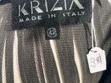 a close up of a black and white jacket with a label on it