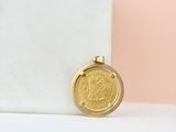 a gold coin sitting on top of a marble block