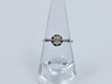 a ring that is sitting on top of a glass vase