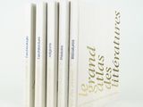 three books are stacked on top of each other on a white surface