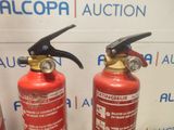 two fire extinguisors sitting next to each other